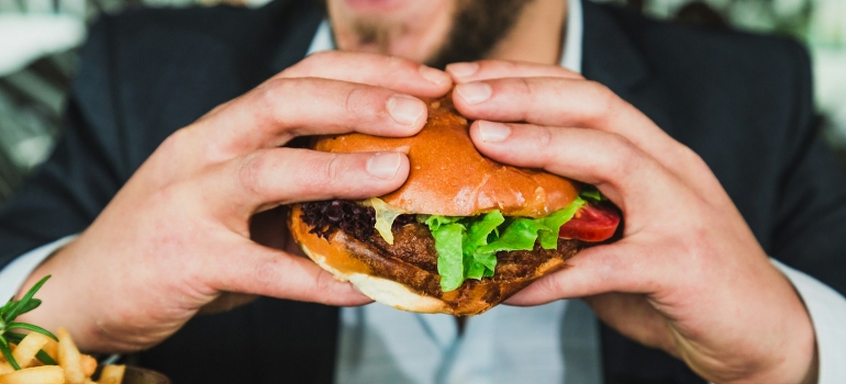 A man holding a burger. 