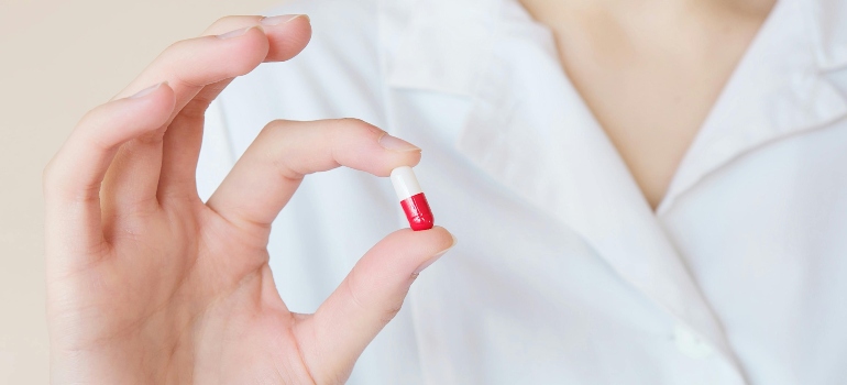 A person holding a pill