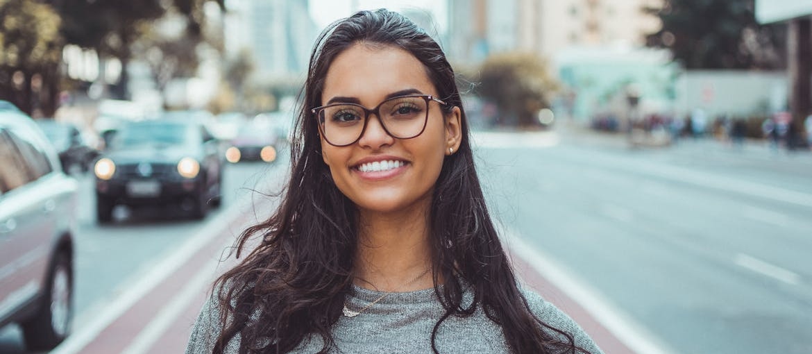 Woman looking at the camera and smiling.