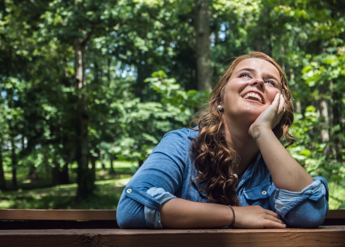 Woman sitting on a bench and enjoying the good weather.