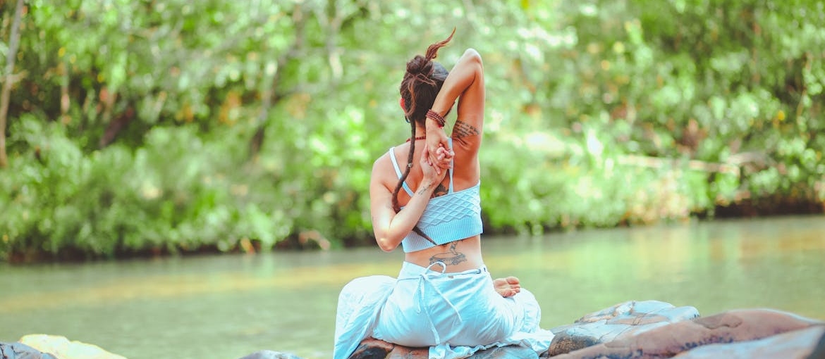 Woman exercising near a body of water during a mental health day.