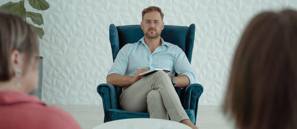 Therapist talking to two of his patients.