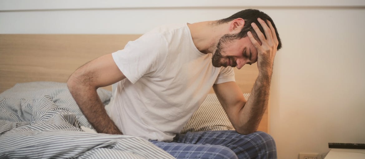 Man feeling sick after mixing stimulants and depressants.