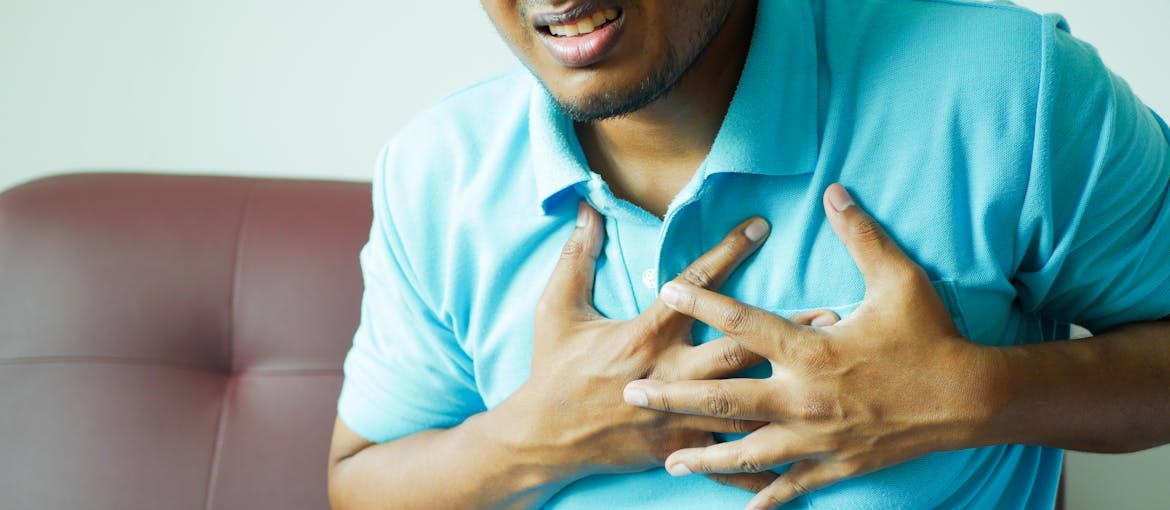 Man holding his chest in pain.