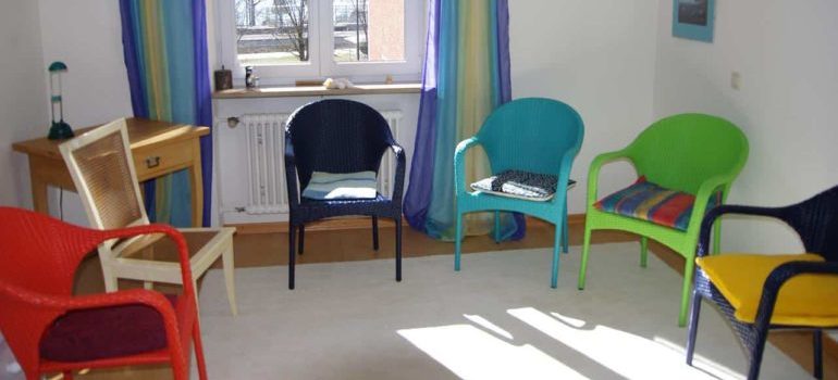 A room after group therapy, with chairs placed in a circle. 