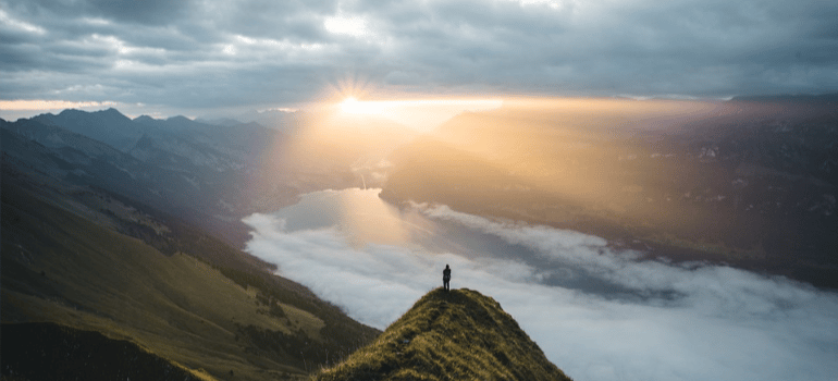 A panoramic view of a mountainous landscape as the sun rises.