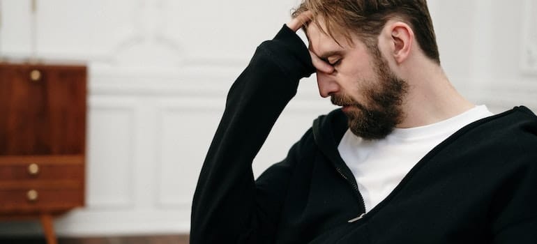 Man holding his head as if in pain.