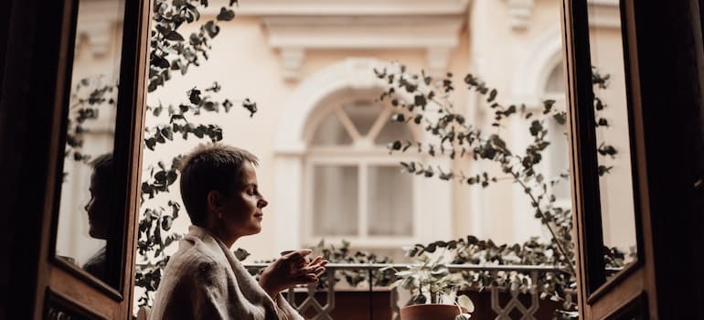 A person drinking coffee on a small balcony as a part of living a heart-healthy lifestyle during your recovery in WV