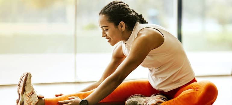 Person stretching on the floor.