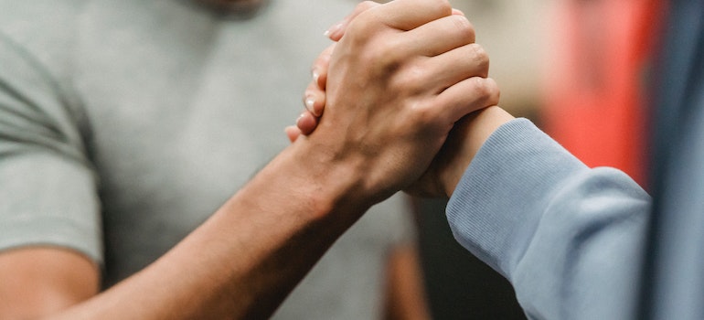 A close-up of a person’s hands as they’re speaking at a group therapy session.