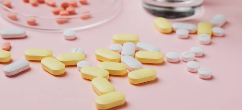 A close-up of tablets on a pink surface.