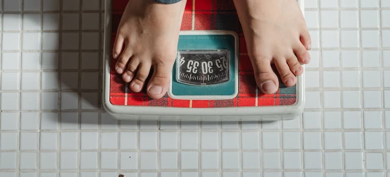 a person weighing on scale
