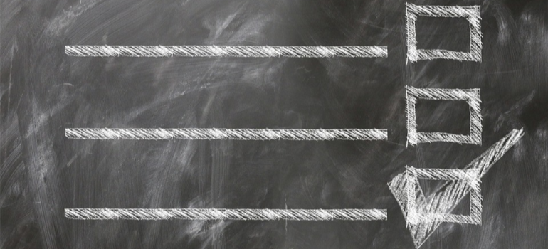 A checklist in chalk on a blackboard.