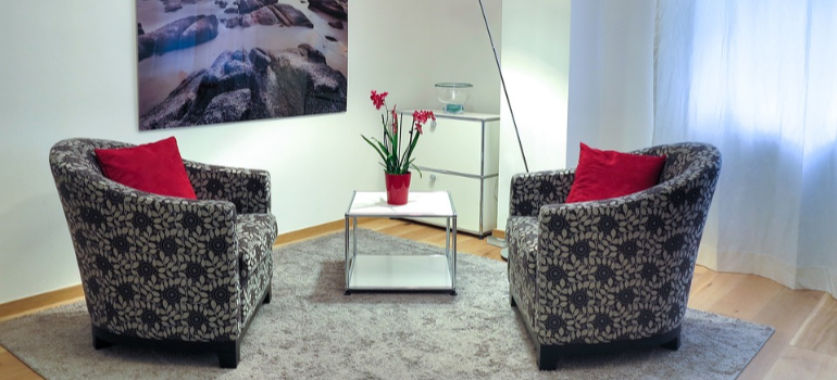 Two armchairs facing each other in a psychotherapist’s office.