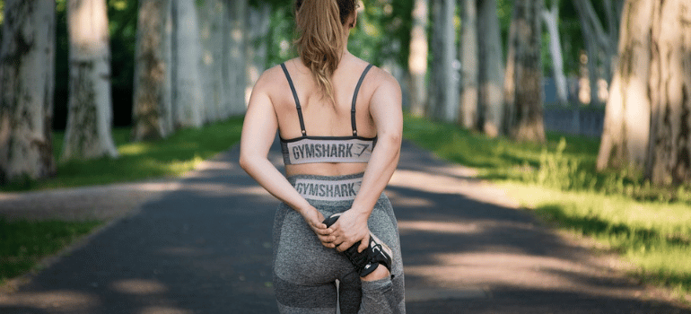 A woman in sports attire outdoors.