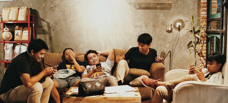A group of young men on a couch hanging out as they learn to love yourself and reclaim your life after an addiction