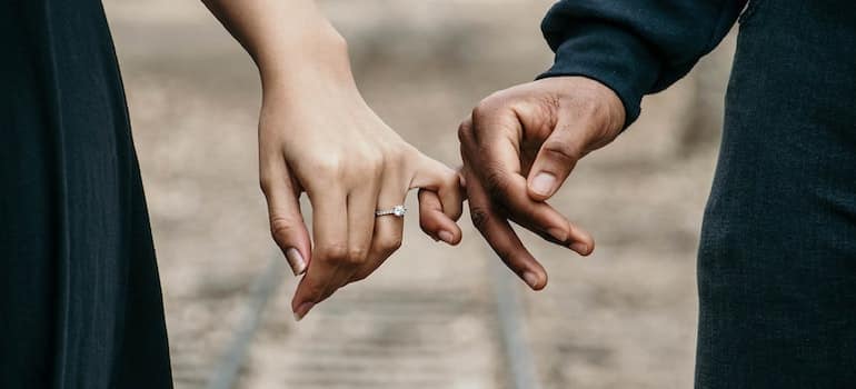 Interracial couple holding hands and breaking the cycle of addiction in families