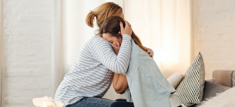 Two women hugging.