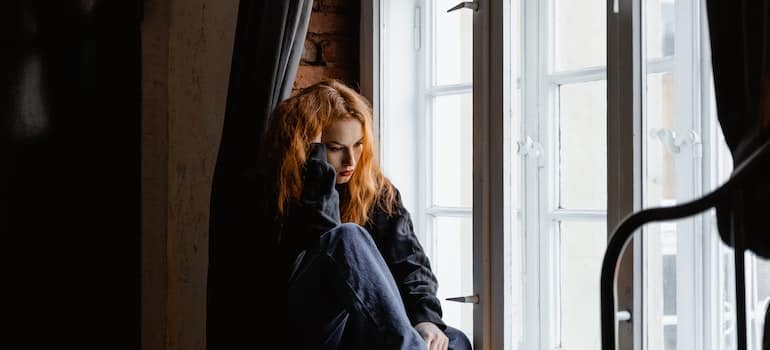 Person sitting on a window sill.