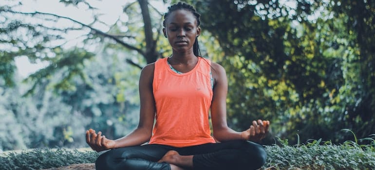 A close-up of a person in a yoga meditation pose.