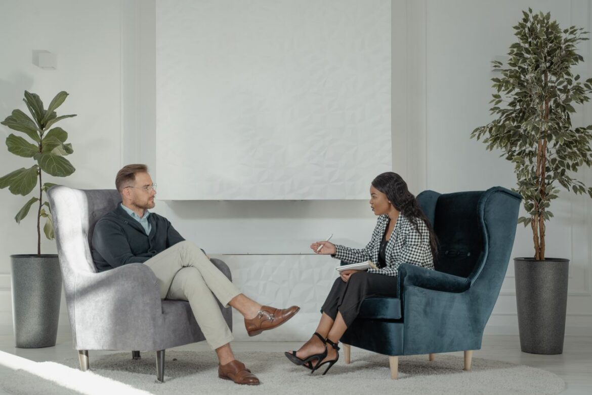 Psychologist and patient talking face-to-face during a counseling appointment.