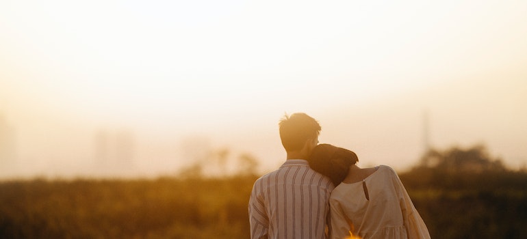 Couple sitting in a field.