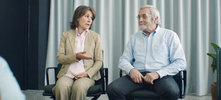 Two seniors, a man and a woman, during a therapy session indoors.