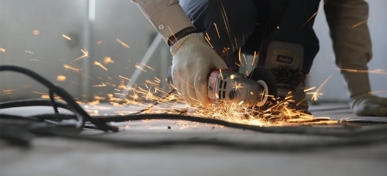A close-up of a person using a grinder indoors representing the article are some professions more prone to addiction than others.