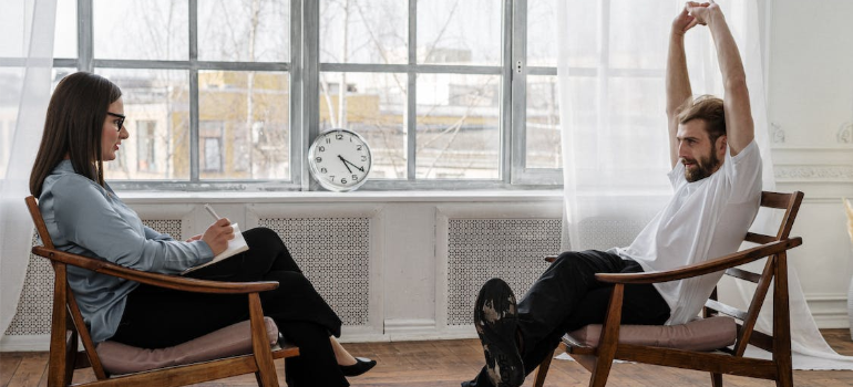 A man stretching his hands during a psychotherapy session.