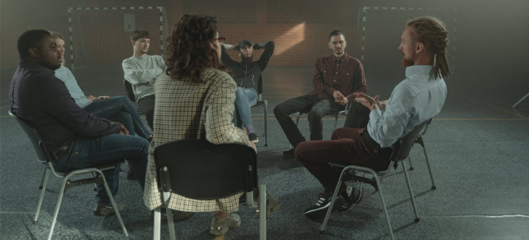 People attending group therapy indoors.