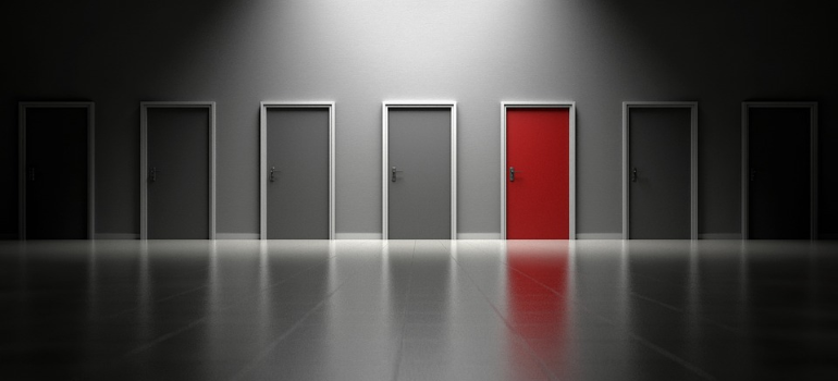 An illustration of a red door around grey ones.