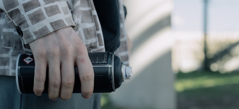 a man holding spray bottle