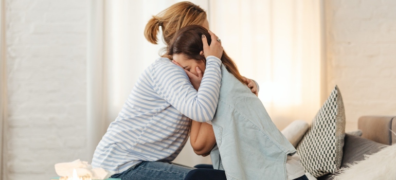 unrecognizable woman supporting her sister during difficult times before choosing one of drug rehab centers in Parkersburg WV