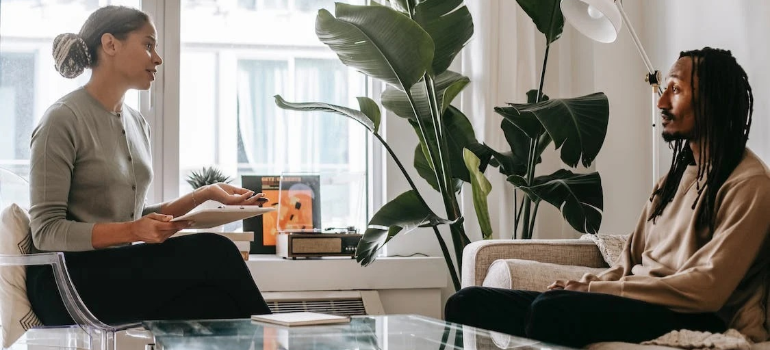 A psychotherapist and her patient during a CBT session indoors.