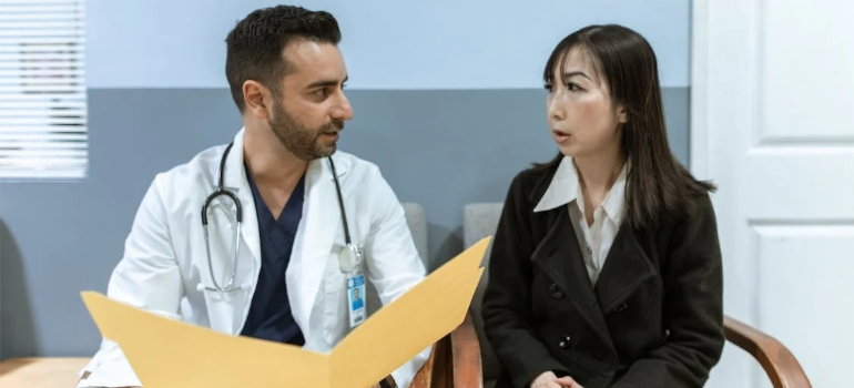 A doctor and a patient discussing indoors.