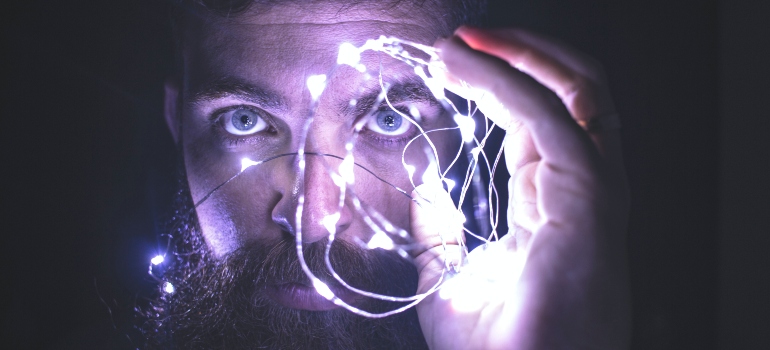 person holding string lights
