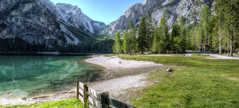 Lake in a forest surrounded by mountains.