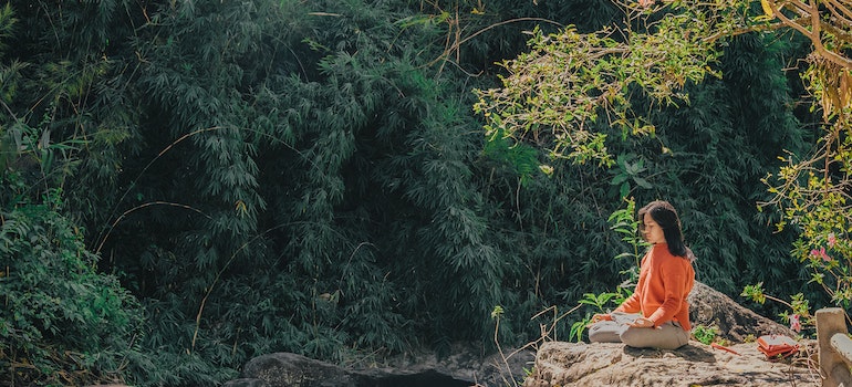 Person medidating in nature.
