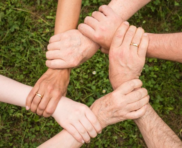 A group of people holding their arms in support