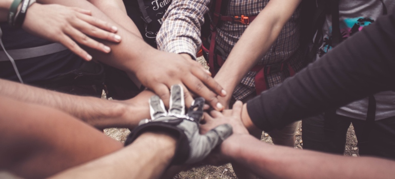 people doing group hand cheer