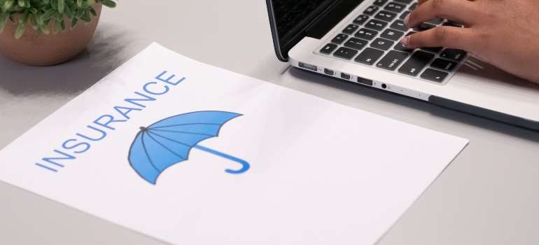a drawinf of a blue umbrella and the word insurance written above it