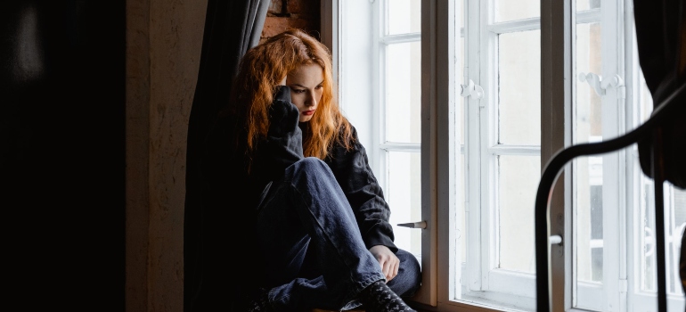 lonely girl sitting by the window