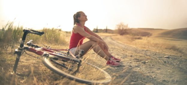 young woman riding a bike as a part of holistic therapy for addiction