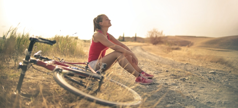 young woman riding a bike as a part of holistic therapy for addiction
