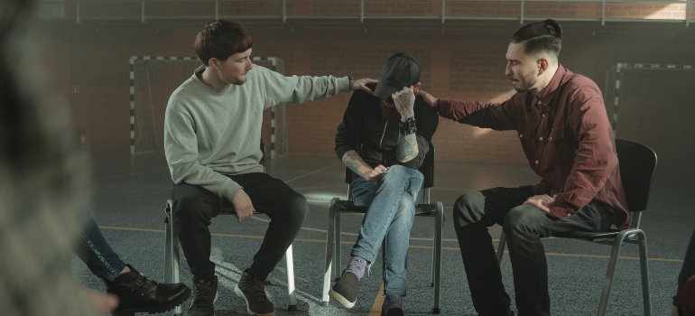 two guys consoling their friend