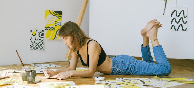 Woman painting on the floor.