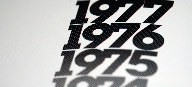 numbers 1975, 1976, and 1977 in black letters