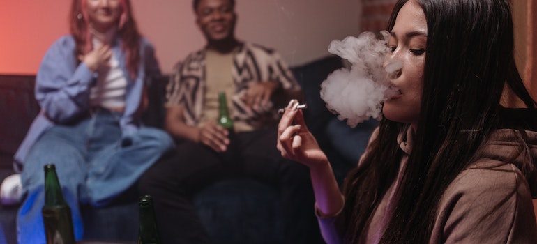 Person smoking at a party.