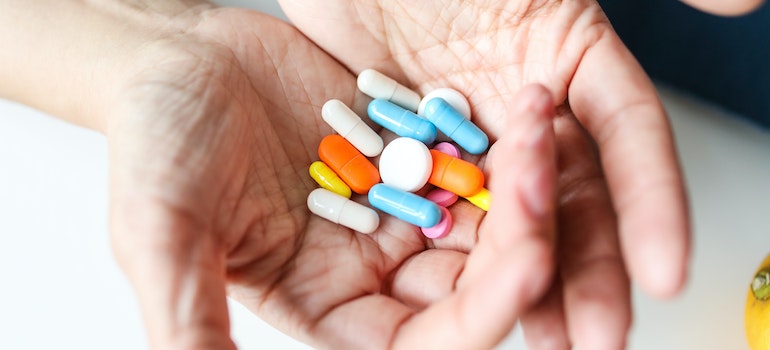 A person with a handful of medications in barbiturates rehab.