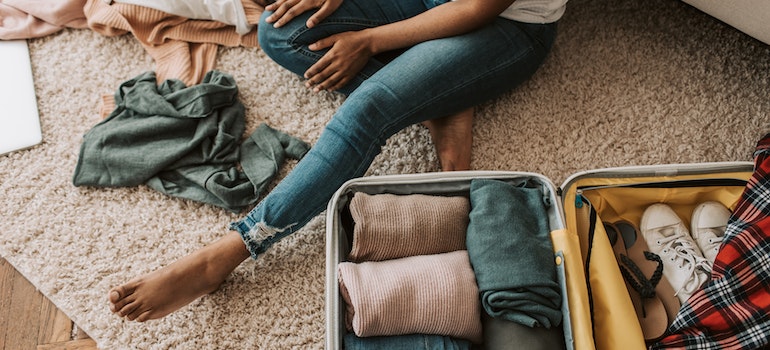 Woman packing a suitcase for a stay in one of the benzodiazepine rehab centers